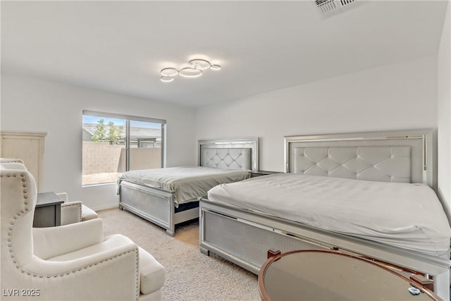 bedroom featuring light colored carpet, visible vents, and baseboards