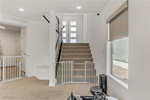 stairs featuring carpet, visible vents, baseboards, and recessed lighting