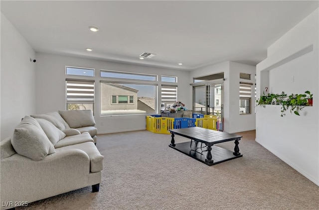 living room with recessed lighting, carpet flooring, visible vents, and baseboards