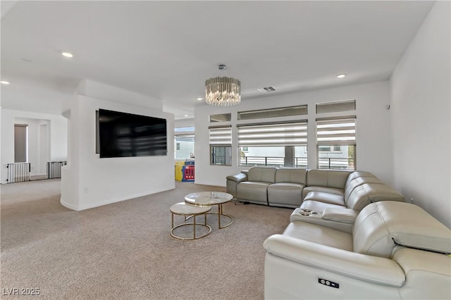 living room with a chandelier, light colored carpet, visible vents, and a healthy amount of sunlight