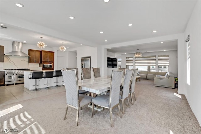 dining space featuring light carpet, recessed lighting, visible vents, and a notable chandelier