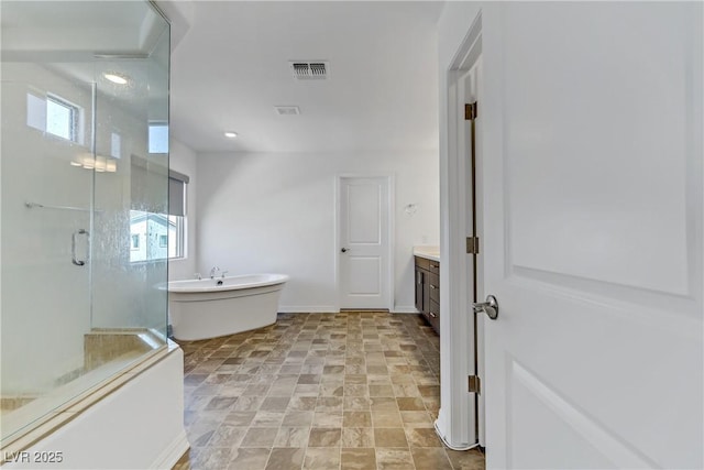 bathroom featuring a wealth of natural light, a soaking tub, visible vents, vanity, and a shower stall