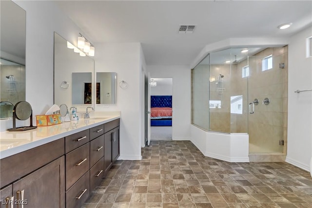 full bathroom featuring a sink, visible vents, baseboards, a stall shower, and ensuite bath