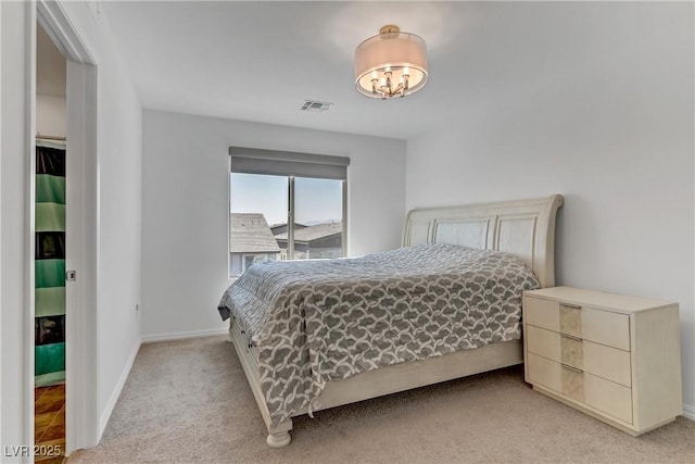 bedroom featuring visible vents, light carpet, and baseboards