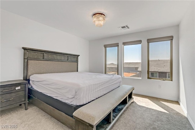 bedroom with light carpet, visible vents, and baseboards