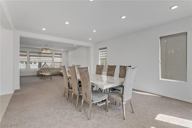 dining space featuring light carpet, baseboards, a notable chandelier, and recessed lighting