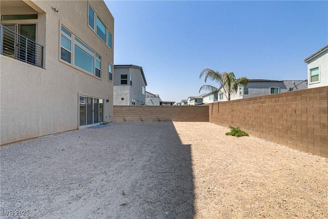 view of yard featuring a patio area, a fenced backyard, and a residential view