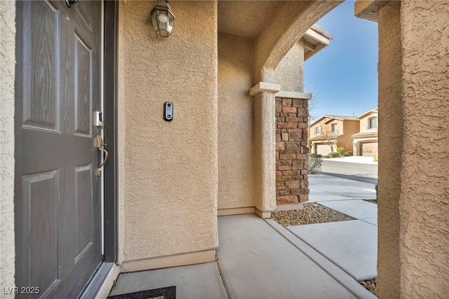 property entrance with a residential view and stucco siding