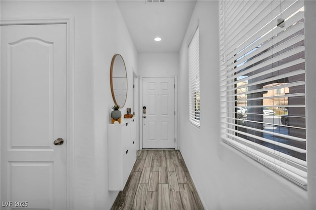 hall with visible vents and wood tiled floor