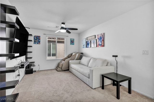 living room with a ceiling fan and light colored carpet