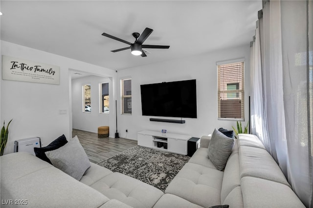 living area with light wood finished floors and ceiling fan