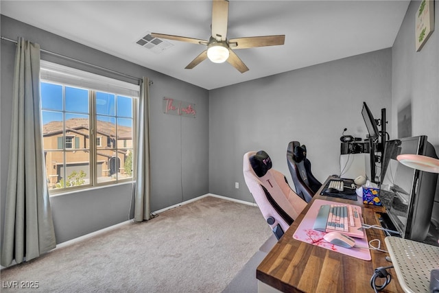 office featuring baseboards, carpet, visible vents, and a ceiling fan