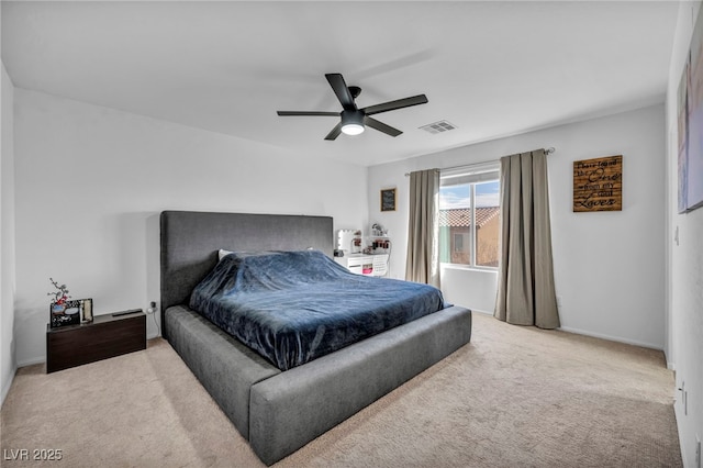 bedroom with visible vents, ceiling fan, and light carpet