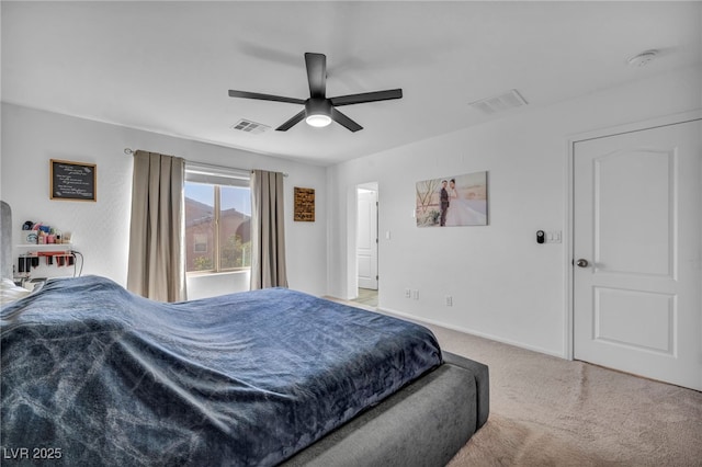 bedroom with light carpet, ceiling fan, visible vents, and baseboards