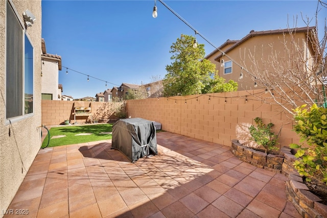 view of patio featuring a fenced backyard and a grill