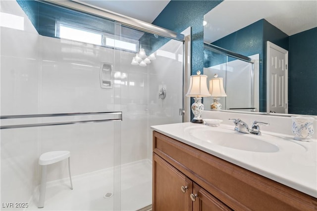 full bathroom featuring vanity and a shower stall