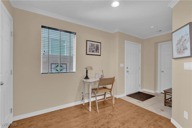 entryway featuring recessed lighting, wood finished floors, baseboards, and ornamental molding