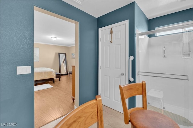 interior space featuring tile patterned flooring, crown molding, and baseboards