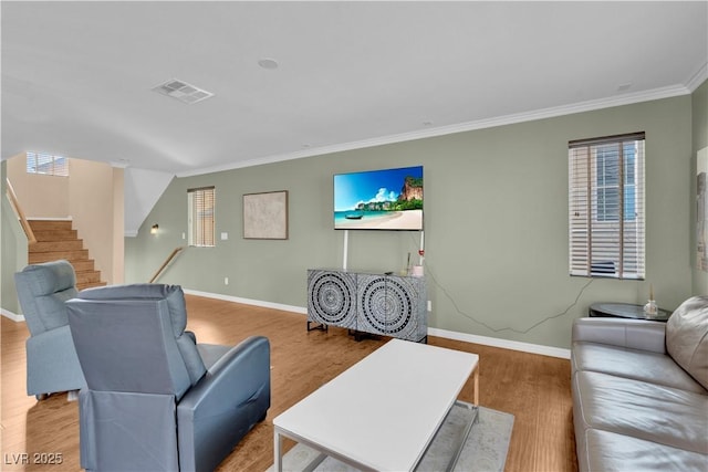 living area with stairway, wood finished floors, visible vents, baseboards, and crown molding