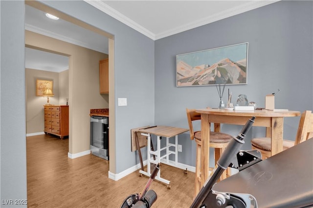 office with crown molding, wine cooler, baseboards, and light wood-type flooring