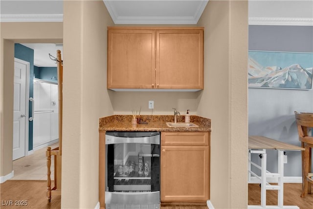 bar featuring crown molding, wet bar, a sink, beverage cooler, and light wood finished floors