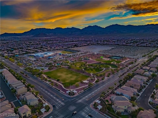 aerial view at dusk with a mountain view and a residential view