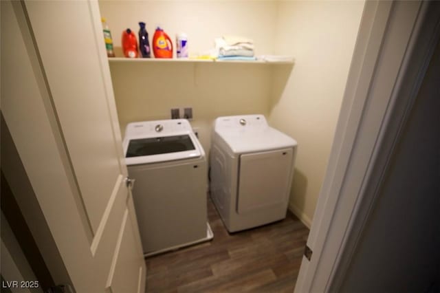 washroom with dark wood-type flooring, laundry area, and washing machine and clothes dryer