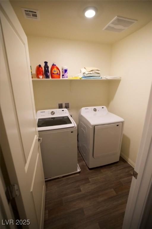 clothes washing area with dark wood finished floors, recessed lighting, visible vents, washing machine and dryer, and laundry area