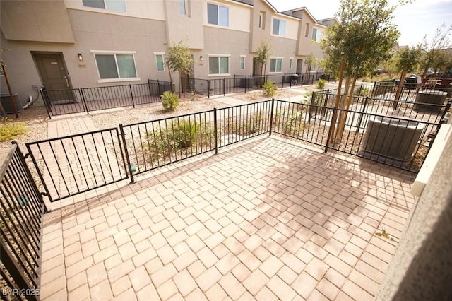 view of patio / terrace with fence and a residential view