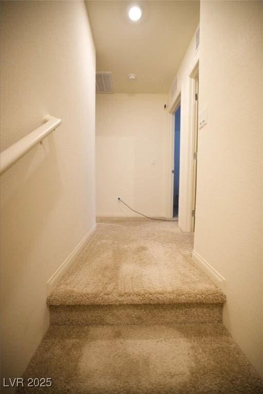 stairs with visible vents and carpet flooring