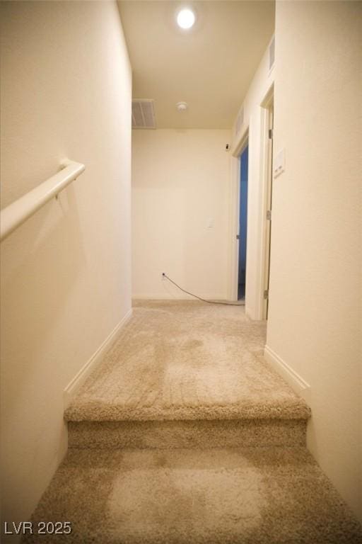 staircase featuring carpet and visible vents