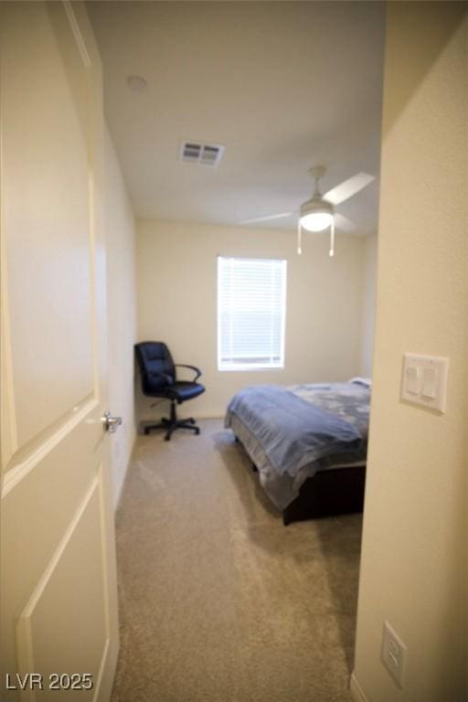 carpeted bedroom featuring visible vents and ceiling fan