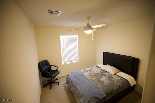 carpeted bedroom featuring ceiling fan and visible vents