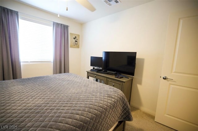 bedroom with light carpet, ceiling fan, visible vents, and baseboards