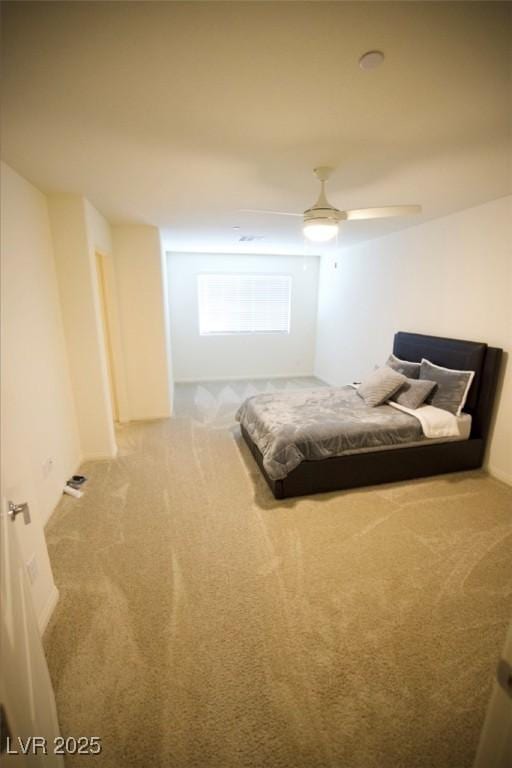 unfurnished bedroom with a ceiling fan and carpet