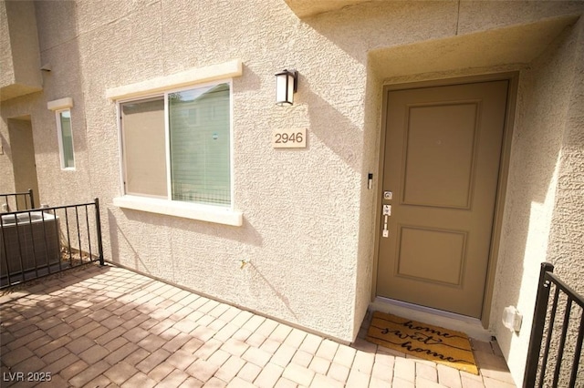 entrance to property with stucco siding