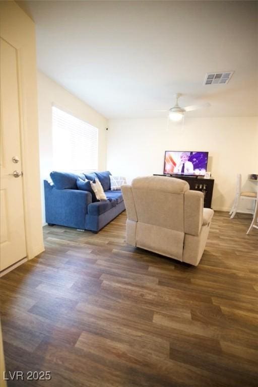 living room with dark wood-style flooring and visible vents