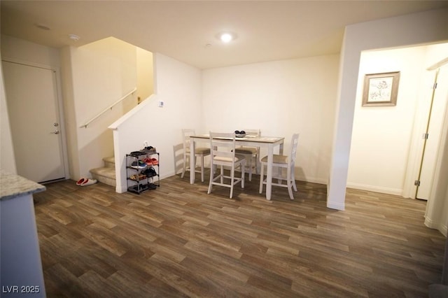 dining room with stairway, dark wood finished floors, and baseboards