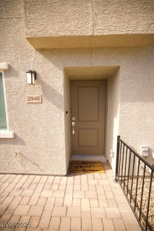 entrance to property with stucco siding