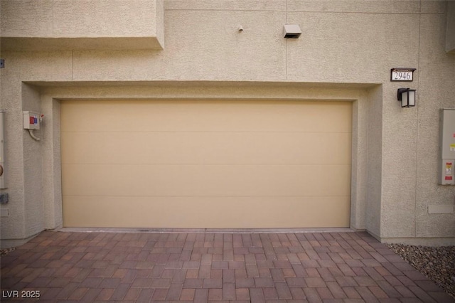 garage featuring decorative driveway