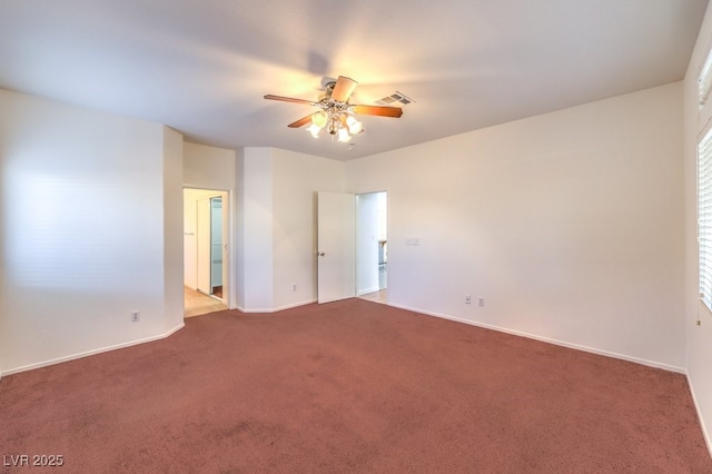 empty room with a ceiling fan, carpet, visible vents, and baseboards