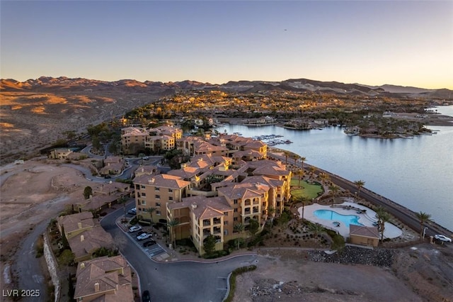 aerial view at dusk with a water and mountain view