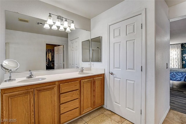 full bath featuring tile patterned flooring, visible vents, and a sink