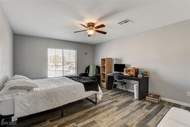 bedroom featuring dark wood-style flooring, visible vents, ceiling fan, and baseboards