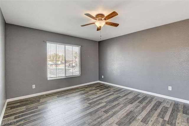 unfurnished room with a ceiling fan, dark wood-style flooring, and baseboards