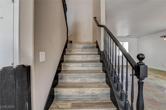 stairway featuring baseboards