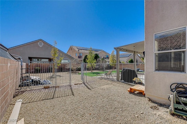 view of yard featuring a patio area, a fenced backyard, and a residential view