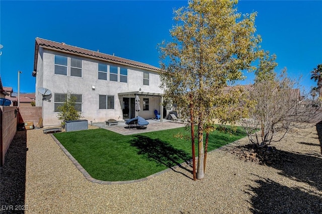 back of house with a fenced backyard, a lawn, stucco siding, a pergola, and a patio area