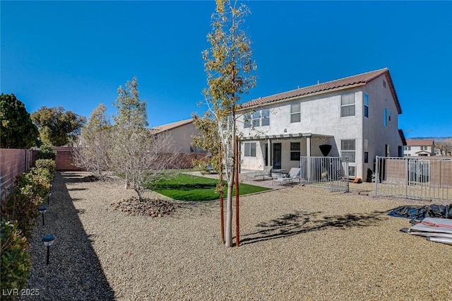 back of property with a patio, stucco siding, a fenced backyard, and a pergola