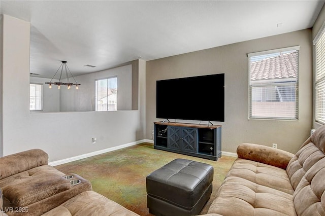 living room featuring plenty of natural light, visible vents, baseboards, and carpet flooring